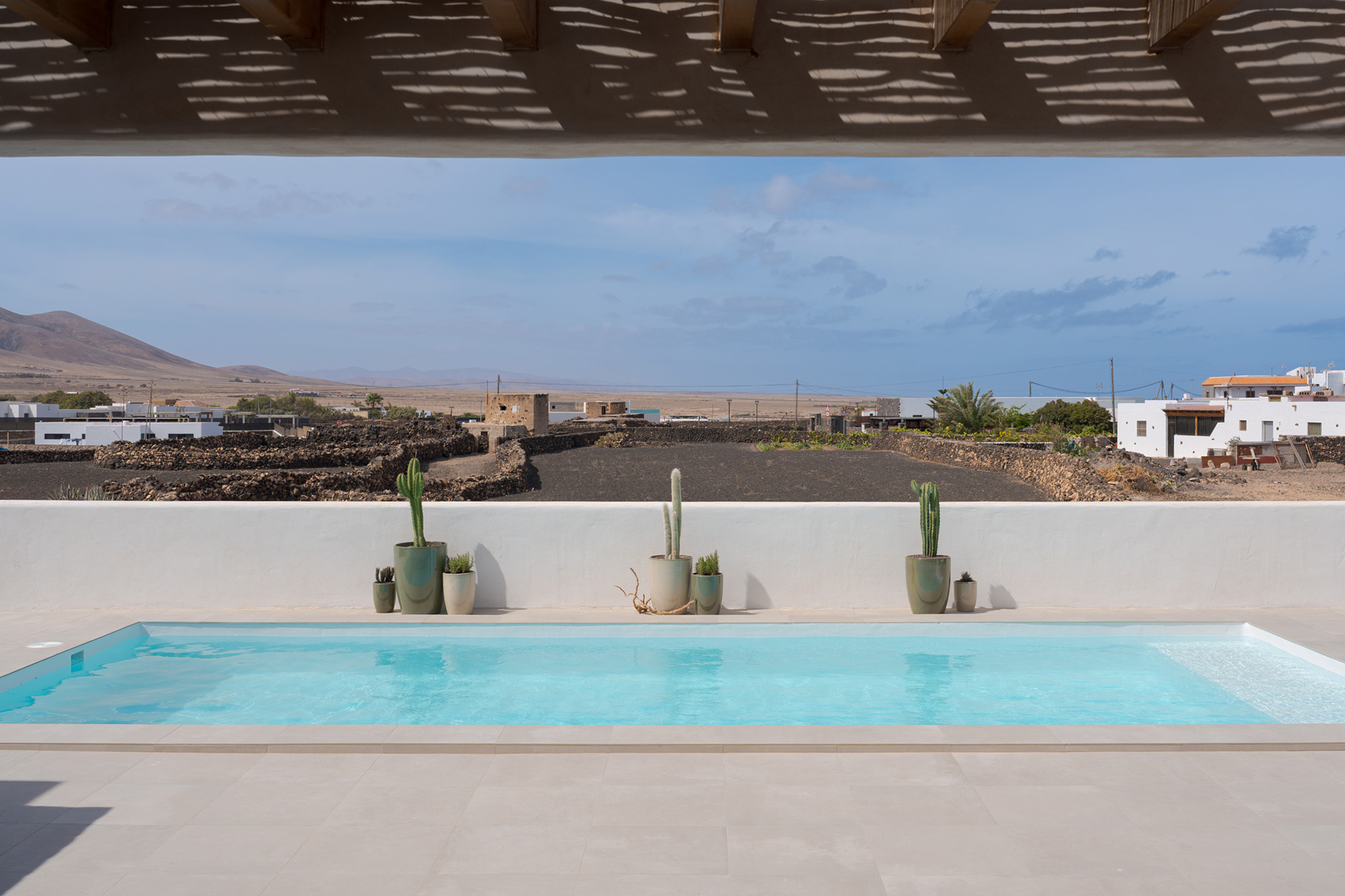 View from the terrace across the pool towards El Roque village and mountains